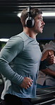 Man, running and treadmill with headphones at gym, audio streaming and music at wellness class. Person, subscription and steps with equipment, workout or exercise for cardio challenge at fitness club