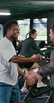 Man, handshake and happy with celebration at gym for goal, training or achievement at cycling club. People, shaking hands and smile with support for fitness, motivation and wellness at spin class