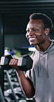 Black man, fitness and workout with dumbbells in gym for muscle development, bicep curl or power. Bodybuilder, weightlifting and strength training for exercise, growth and wellness in club with smile