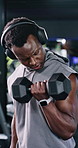 Headphones, fitness or black man with weights in gym, streaming music or strength challenge for workout. Muscle development, dumbbells or happy athlete with audio tech for radio, exercise or training