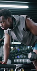 Sports, weights and black man in gym with workout, bodybuilding or training for strength. Equipment, strong and African male athlete with dumbbells for exercise with arm muscles in fitness center.