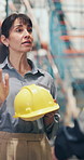 Logistics, speaking and woman with helmet in warehouse, safety training or compliance regulations. Gear policy, accident prevention talk or mature speaker with depot rules, briefing or risk education