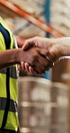 Business people, meeting and warehouse with handshake for supply chain deal or partnership. Closeup, supplier or distributor shaking hands with agreement for b2b logistics or storage distribution
