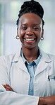 Face, doctor and happy black woman with arms folded for medical wellness, about us and pride. Portrait, employee and confident professional in hospital, expert physician and healthcare worker