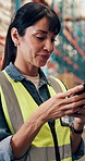Woman, smile or typing in warehouse with phone, supply chain email or text message for quality control. Mature person, scroll or browsing in depot with tech, online chat and mobile app for logistics.