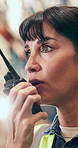 Woman, talking and logistics with radio in warehouse for schedule, inventory and shipping. Mature person, inspection and listening to discussion, supervisor instructions and feedback for distribution