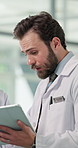 Hospital, doctors and man with tablet, discussion and medical report for treatment plan and meeting. Clinic, healthcare workers and collaboration with diagnosis on website, talk and people with tech