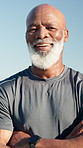Black man, face and arms crossed for fitness, outdoor and happy in portrait, sky or confident in summer. Mature African person, smile and runner with pride for wellness, exercise or break in Nigeria