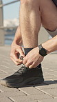 Hands, runner or tie shoes outdoor to start running, morning cardio or exercise preparation. Feet, person or fasten laces on promenade for jogging comfort, fitness routine or getting ready to workout