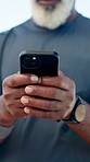 Hands, fitness and man with smartphone, outdoor and digital app to track progress. Closeup, communication and mature person with cellphone, wellness and online reading for workout schedule and email