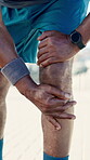 Man, legs outdoor and knee pain from workout challenge, difficult exercise or medical emergency. Active, person or athlete in urban town with joint inflammation, strain or problem from sports injury.