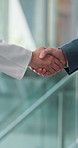 Business, person and handshake with doctor in hospital for offer, partnership and medical subsidies. People, shaking hands and surgeon with thank you, agreement and negotiation for healthcare funding