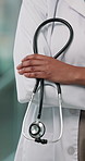 Doctor, hands and healthcare service with stethoscope for professional medical help in hospital. Person, closeup or health expert with arms crossed, equipment or uniform for emergency checkup clinic