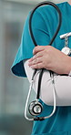 Nurse, hands and healthcare service with stethoscope for professional medical help in hospital. Person, closeup or health expert with arms crossed, equipment or uniform for emergency checkup clinic