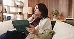 Woman, thinking and research with tablet on sofa for network, connectivity or decision in home. Female person, freelancer or remote work with technology or contemplating for online option or choice