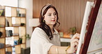 Girl, painting and artist in house with easel, hobby and creative process with stroke for project. Woman, inspiration and tools for texture, design or skills for talent, canvas or craft at apartment