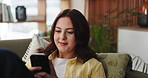 Phone, relax and social media with woman on sofa in living room of home for post or update. App, search and typing on mobile with happy person in apartment for break, communication or me time