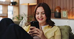 Laughing, phone and social media with woman on sofa in living room of home for post or update. App, funny and typing on mobile with happy person in apartment for break, communication or me time