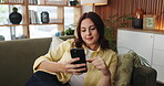 Phone, scroll and social media with woman on sofa in living room of home for post or update. App, mobile search and smile with happy person in apartment for browsing, communication or me time