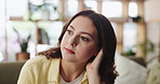 Thinking, stress and woman in home with headache, regret or lost in thoughts in living room. Migraine, reflection and sad female person in house with decision, lonely or anxiety for mental health