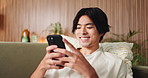 Asian man, student and reading with phone in house for education results, university application or acceptance. Person, tech and good news of study registration, scholarship feedback and notification