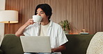 Coffee, remote work and typing on laptop with Asian man on sofa in home living room for planning. Computer, drink and startup research with freelance entrepreneur in apartment for small business
