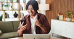 Fist pump, phone and remote work with Asian man in living room of home for alert or notification. laptop, good news and startup with freelance entrepreneur in apartment for small business success