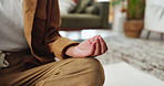 Person, hands and zen with meditation in home for spiritual wellness, mindfulness or awareness. Closeup, calm yogi or breathing exercise for inner peace, chakra balance or healing on floor in house
