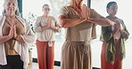 Yoga, women and prayer hands in meditation class, mindfulness or breathing for peace in retirement. Yogi, senior people and group with spiritual exercise, zen or holistic fitness in wellness studio