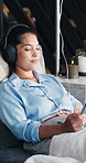 Headphones, infusion and tablet with woman in drip lounge for injection of saline solution or vitamins. App, relax and streaming with person in wellness clinic for healing, hydration or iv therapy