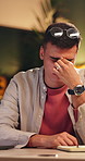 Burnout, stress and thinking with designer man in office at night for eye strain or fatigue. Brain fog, glasses and headache with employee at desk in dark design workplace for pressure or tension