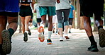 Legs, people and marathon competition in nature for fitness challenge, sport event and running. Runners, shoes of group and race contest at park for endurance test, jogging pace or cardio performance