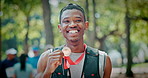 Sports, nature and face of man at marathon, achievement or running workout with competition. Happy, medal and portrait of male athlete with pride for winning at race outdoor in park with reward.
