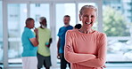 Face, fitness and arms crossed with old woman in studio for mobility workout, health or joint friendly exercise. Wellness, learning or senior training group with person in club for smile and hobby