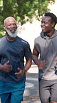 Personal trainer, running and men with fitness, smile and discussion for motivation, advice and exercise. Outdoor, runners or African people in street, talking and support for challenge and endurance
