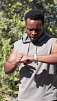 Runner, check time and black man with fitness, smile and cardio workout with challenge. Wellness, athlete or African person in street, exercise or smart watch to track progress. endurance or training