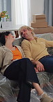 Happy couple, relax and moving in new home with sofa for comfort, purchase or furniture decor. Man, woman or rest with smile on couch for relocation, renovation or fresh start together in house