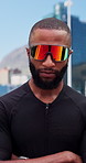 Black man, arms crossed and fitness in town with sunglasses for wellness, serious and confidence in road. African person, runner and ready in street with pride, exercise and shades in urban city