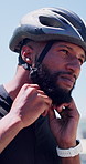 Cyclist, man and fasten helmet in city for cycling safety, exercise and getting ready for training. Transportation, athlete and headgear preparation for ride protection, fitness and sports workout