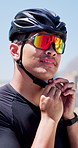 Sunglasses, man and fasten helmet in city for cycling safety, exercise and getting ready for training. Athlete, cyclist and headgear preparation for ride protection, fitness and sports workout
