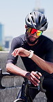 Black man, bicycle and smart watch in city for training with timer, thinking or heart rate for cardio exercise. African person, iot clock and sunglasses for cycling, bike or fitness app in urban town