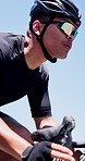 Cycling, hands and man on bike outdoor for practice, competition and exercise on road for journey. City street, cyclist and athlete on bicycle for low angle, travel and eco friendly transport