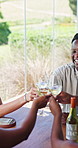 Cheers, friends and man in restaurant with wine for social gathering, reunion and tasting event. Talking, weekend and people with alcohol, drinks and toast for bonding, connection and celebration