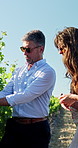 Nature, tourism and people in vineyard for wine tasting, travel experience and learning on holiday. Farm, outdoor and man and woman in countryside for vacation, tour guide and winery information