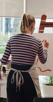 Back, woman and painting in home with canvas, diy project and craft process for creative expression. Artist, person and easel in apartment with talent, illustration skills and paintbrush for artwork.