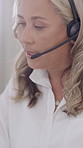 Contact us, call center and woman talking for technical support, help and writing notes. Notebook, speaking and mature agent with headset for communication, troubleshooting or customer service for IT