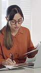 Woman, laptop and documents with review for remote work from home, typing and admin job with notebook. Person, computer and virtual assistant with paperwork, feedback and freelance project at house
