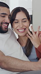 Couple, video call and hug with engagement on sofa with ring, excited and announcement in living room. Happy woman, man and virtual chat for wedding proposal, partner and love in lounge at apartment