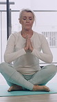Laptop, home and senior woman with prayer hands for online meditation, mindfulness and calm. Yoga mat, house and mature person with computer for guided tutorial for health, wellness and zen energy