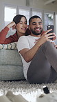 Couple, phone and relax in home on sofa with hug, talk and share meme in living room for bonding. Happy woman, man and embrace with smartphone, mobile app and funny video on social media at apartment